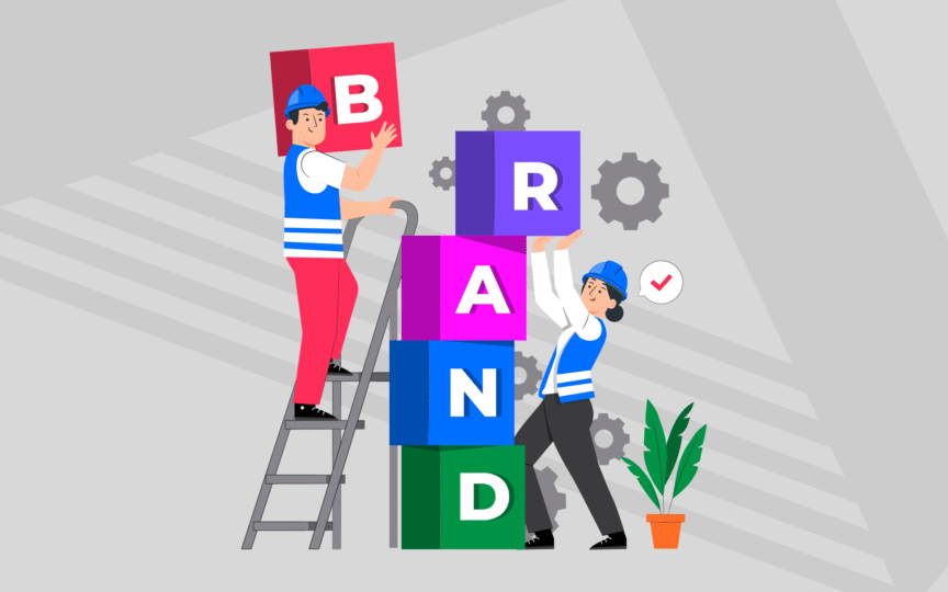Two people in construction gear stacking colourful blocks spelling “BRAND,” symbolising building and strengthening brand architecture.