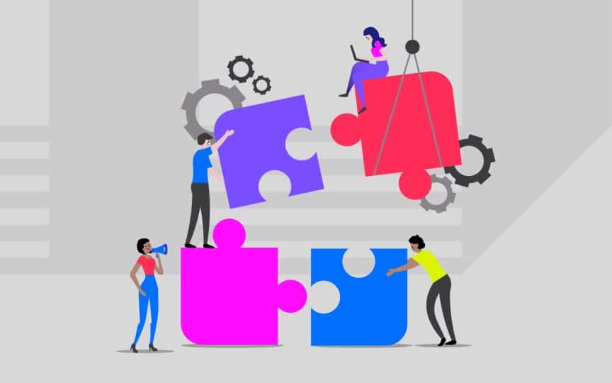 Illustration of five people assembling oversized, colorful puzzle pieces in a teamwork setting. One person is using a megaphone, another is lifting a puzzle piece, a third is pushing a piece into place, and one person is sitting on a suspended piece working on a laptop. Gear icons in the background suggest collaboration and problem-solving.
