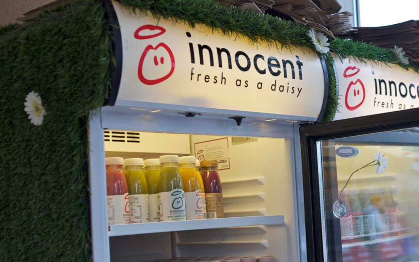 Innocent Drinks fridge display with smoothies, promoting natural nutrition and transparency.
