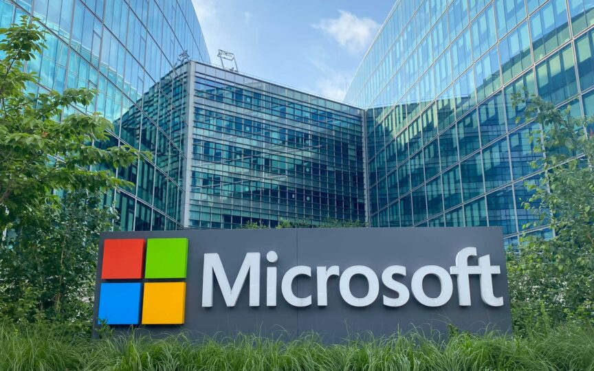 Microsoft headquarters exterior with logo and greenery.