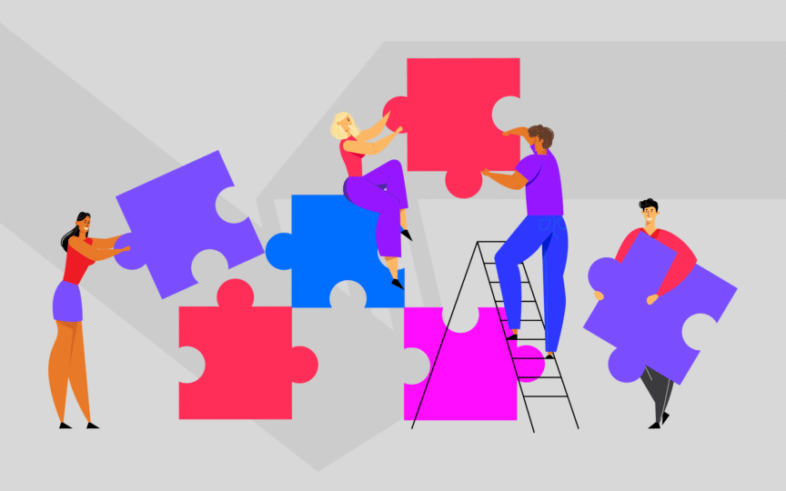 Group of people putting together puzzle pieces.